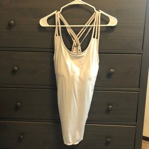 Off white athleta tanktop with crisscross straps, built in bra, large.
